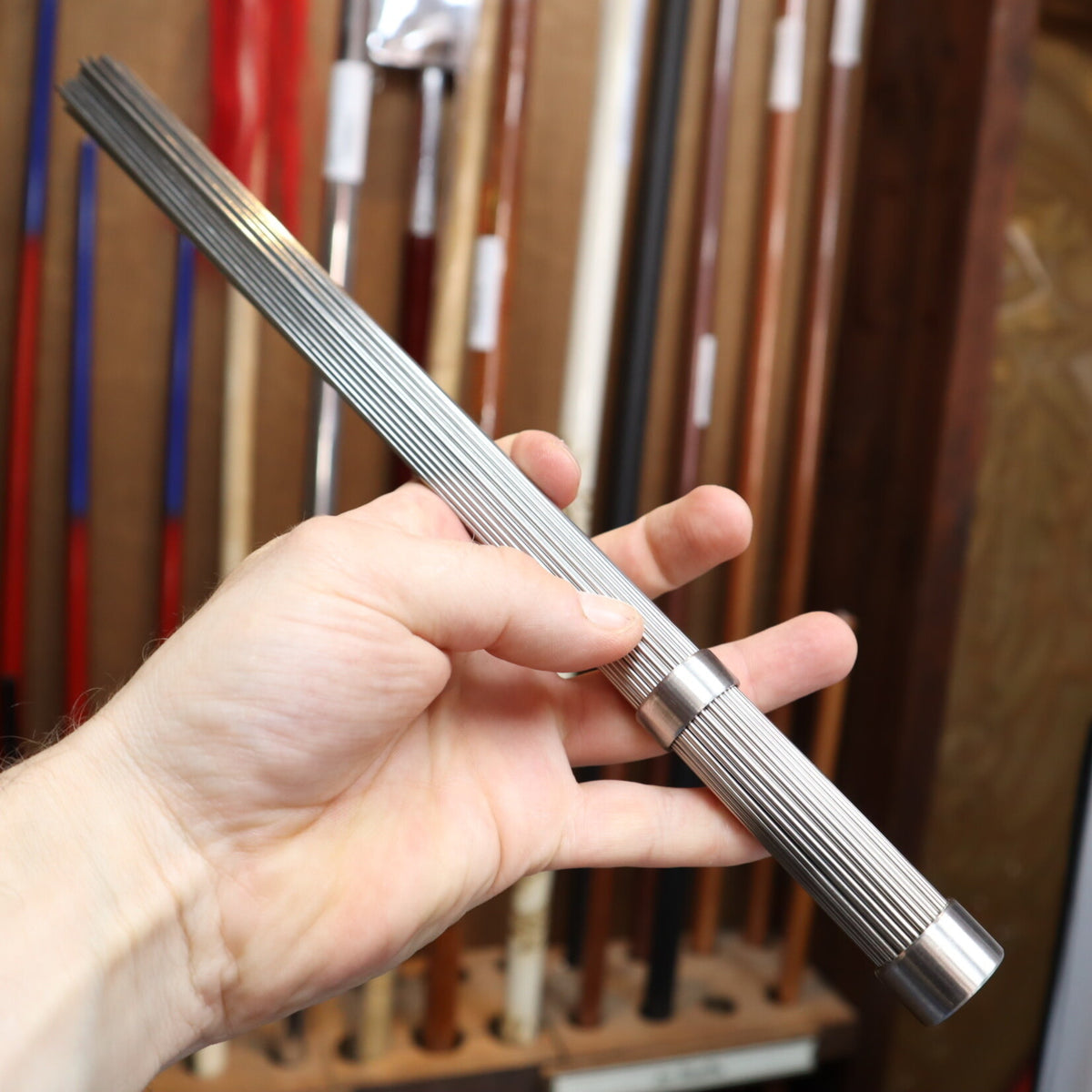 qi gong metal massage brush in hand